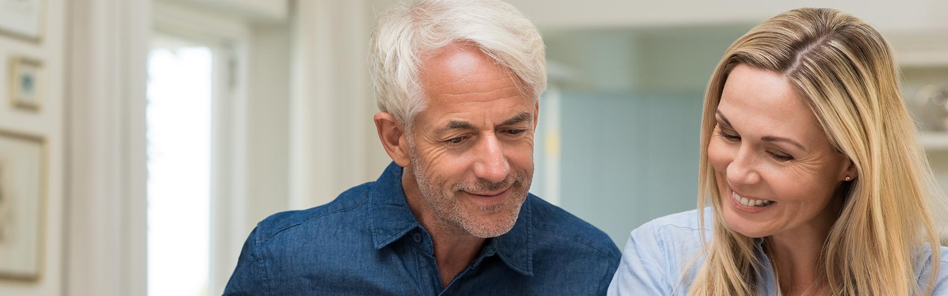Middle aged couple researching online Middle aged couple researching online