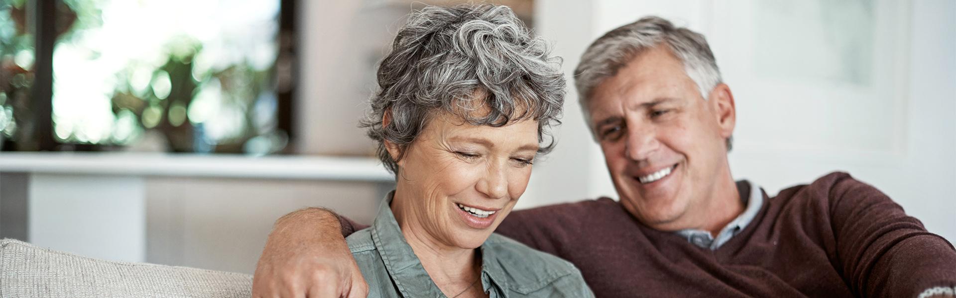 Middle aged couple researching online Middle aged couple researching online