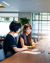 Female researchers examining data