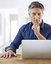 Middle aged man researching online Middle aged man researching online