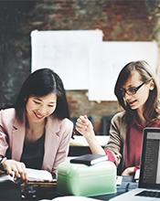 Female researchers examining data