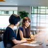 Women discussing financial data