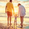 Young family walking along the beach