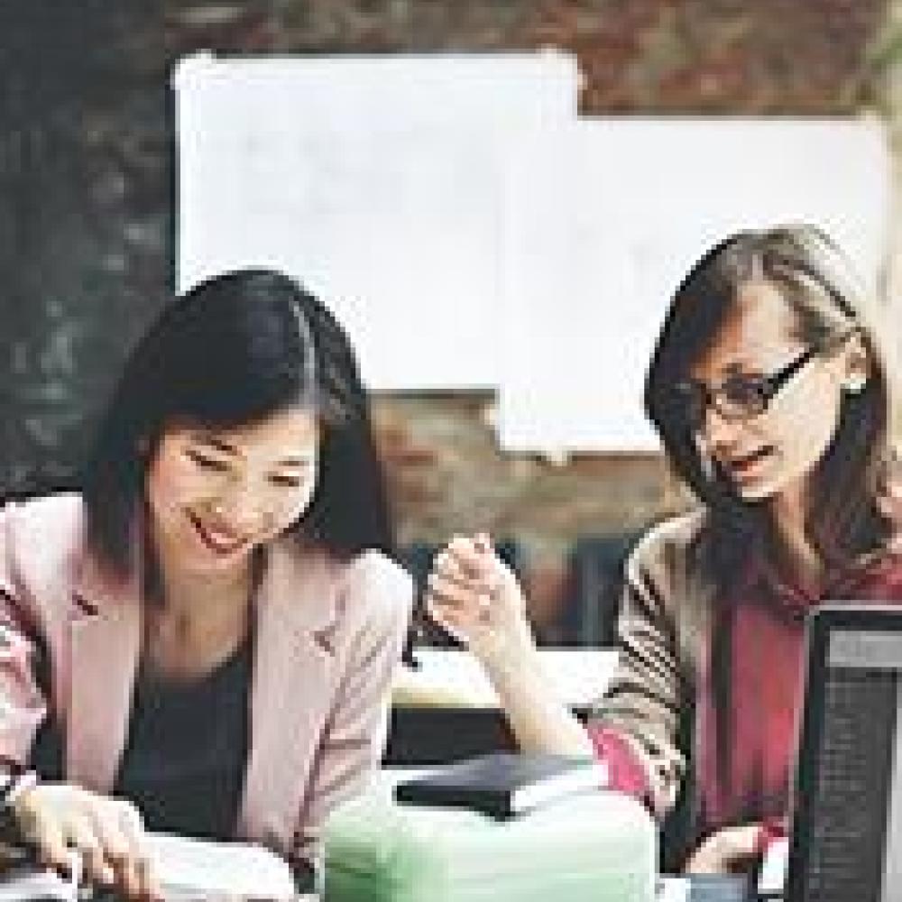Female researchers examining data
