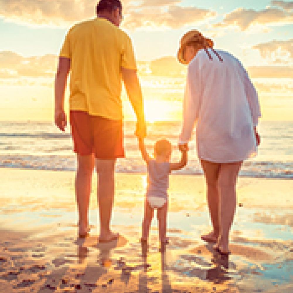 Young family walking along the beach